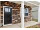 Inviting entrance with stone accents, a black door, white columns and the house number at 4618 Harris Elliot Rd, Lincolnton, NC 28092