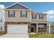 Two-story home with stone accents, a two-car garage, black shutters, and a well-manicured lawn at 4618 Harris Elliot Rd, Lincolnton, NC 28092