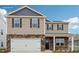 Charming two-story home featuring a stone accents, a two-car garage, and inviting front porch at 4618 Harris Elliot Rd, Lincolnton, NC 28092