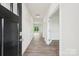 Bright hallway featuring wood floors, white walls, and doors leading to other rooms at 4618 Harris Elliot Rd, Lincolnton, NC 28092