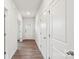 Bright hallway featuring wood-look floors and white doors, adding warmth and character to the house at 4618 Harris Elliot Rd, Lincolnton, NC 28092