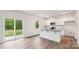 Modern kitchen featuring white cabinets, stainless steel appliances, a gray countertop, and a view to the backyard at 4618 Harris Elliot Rd, Lincolnton, NC 28092
