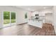 Modern kitchen features an island with seating, stainless steel appliances, and backyard views through sliding glass doors at 4618 Harris Elliot Rd, Lincolnton, NC 28092