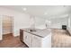 Gourmet kitchen island with a stainless steel sink and faucet, white cabinetry and hardwood flooring at 4618 Harris Elliot Rd, Lincolnton, NC 28092