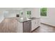 Contemporary kitchen island featuring stainless steel appliances and hardwood flooring with natural light at 4618 Harris Elliot Rd, Lincolnton, NC 28092