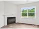 Cozy living room featuring a fireplace, a large window that lets in ample natural light, and neutral wall color at 4618 Harris Elliot Rd, Lincolnton, NC 28092