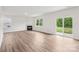 Bright living room featuring wood floors, white walls, and a fireplace at 4618 Harris Elliot Rd, Lincolnton, NC 28092