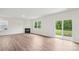 Open living space with fireplace and a large window showcasing a green backyard with a sliding glass door at 4618 Harris Elliot Rd, Lincolnton, NC 28092