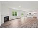 Open floor plan featuring a fireplace and kitchen area with an island and large windows overlooking the backyard at 4618 Harris Elliot Rd, Lincolnton, NC 28092