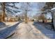 Snow-covered backyard with trees and shadows at 520 Waddell Dr, Albemarle, NC 28001