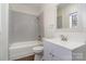 Clean bathroom with a shower/tub, white vanity, and gray tile at 520 Waddell Dr, Albemarle, NC 28001