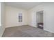 Bright bedroom with carpet flooring, neutral walls, and access to another room at 520 Waddell Dr, Albemarle, NC 28001