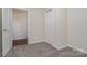 Small bedroom with carpet, closet and door to another room at 520 Waddell Dr, Albemarle, NC 28001