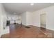 Open concept living room with hardwood floors and views into the kitchen at 520 Waddell Dr, Albemarle, NC 28001