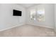 Bright bedroom with neutral walls and carpet, featuring two windows at 545 Shallowford Dr, Rock Hill, SC 29732