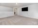 Neutral walls and carpet with a mounted TV. Ceiling light and a doorway to another room at 545 Shallowford Dr, Rock Hill, SC 29732