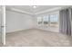 Bright bedroom with neutral walls and carpet, featuring three windows at 545 Shallowford Dr, Rock Hill, SC 29732