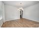 Spacious dining room with wood floors and modern chandelier, ready for entertaining at 545 Shallowford Dr, Rock Hill, SC 29732