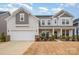 Two-story house with gray siding, brick accents, and a two-car garage at 545 Shallowford Dr, Rock Hill, SC 29732