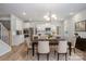 Modern kitchen with a dining table, stainless steel appliances, and sleek white cabinets, ready for culinary adventures at 545 Shallowford Dr, Rock Hill, SC 29732