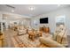 Inviting living room featuring neutral tones, a large TV, and an open floor plan leading to the kitchen at 545 Shallowford Dr, Rock Hill, SC 29732