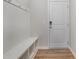 A clean mudroom with a white storage bench and coat hooks by the front door at 545 Shallowford Dr, Rock Hill, SC 29732