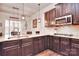 Modern kitchen with dark wood cabinets and granite countertops at 5600 Ballenger Ct, Waxhaw, NC 28173