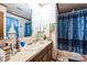 Bathroom featuring a vanity with sink, mirror, towels and blue shower curtain at 5701 Glenshire Ct, Charlotte, NC 28269