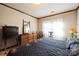 Cozy bedroom with dresser, mirror, and window views at 5701 Glenshire Ct, Charlotte, NC 28269