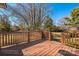 Wooden deck in backyard overlooking yard and trees with railing at 5701 Glenshire Ct, Charlotte, NC 28269