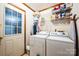 Functional laundry room featuring a washer, dryer, storage shelves and door to exterior at 5701 Glenshire Ct, Charlotte, NC 28269