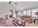 Inviting living room with carpet, a fan, and a glimpse into other rooms at 5701 Glenshire Ct, Charlotte, NC 28269