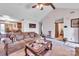 Open-concept living room with a ceiling fan, view of kitchen, and lots of natural light at 5701 Glenshire Ct, Charlotte, NC 28269