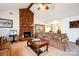 Bright living room featuring vaulted ceilings, and a brick fireplace at 5701 Glenshire Ct, Charlotte, NC 28269