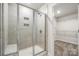 Clean bathroom with walk-in shower and tile surround at 717 Windage Way, Pineville, NC 28134