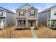 Two-story brick home with a front porch and landscaped yard at 717 Windage Way, Pineville, NC 28134