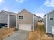 Two-car garage with driveway, additional storage at 717 Windage Way, Pineville, NC 28134