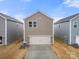 Two-car garage with driveway and additional storage at 717 Windage Way, Pineville, NC 28134