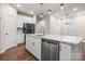 Modern kitchen island with white cabinets and stainless steel dishwasher at 717 Windage Way, Pineville, NC 28134