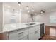 Kitchen island with sink, views into adjacent dining and living areas at 717 Windage Way, Pineville, NC 28134