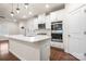 Modern kitchen with white cabinets, stainless steel appliances, and island at 717 Windage Way, Pineville, NC 28134