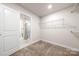 Bright walk-in closet with wire shelving and carpet flooring at 717 Windage Way, Pineville, NC 28134