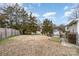 Spacious backyard with a large grassy area and mature trees at 844 Turning Point Ln, Concord, NC 28027