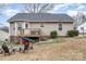 House's back elevation, deck, and firepit seating area in the backyard at 844 Turning Point Ln, Concord, NC 28027