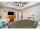 Main bedroom with king-size bed, ceiling fan, and built-in shelving at 844 Turning Point Ln, Concord, NC 28027