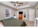 Main bedroom with king-size bed, ceiling fan, and ample closet space at 844 Turning Point Ln, Concord, NC 28027