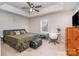 Main bedroom with a king-size bed, ceiling fan, and workspace at 844 Turning Point Ln, Concord, NC 28027