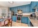 Kitchen boasts teal cabinets, stainless steel appliances, and an eat in area at 844 Turning Point Ln, Concord, NC 28027