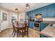 Eat-in kitchen with teal cabinets and stainless steel appliances at 844 Turning Point Ln, Concord, NC 28027