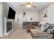 Living room with L-shaped sofa and a cozy fireplace at 844 Turning Point Ln, Concord, NC 28027